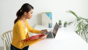 assistant comptable utilisant ordinateur et documents